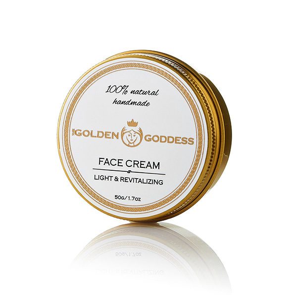 circular gold container with face cream the golden goddess label